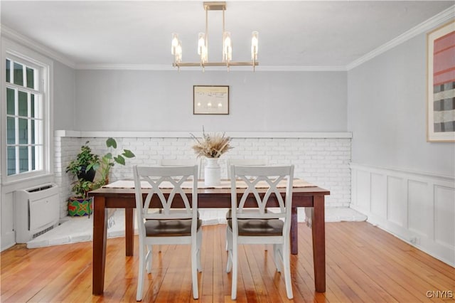 2875 W Lake Rd, Cazenovia, NY 13035 - dining room with light wood-style flooring, ornamental molding, a wainscoted wall, heating unit, and a chandelier