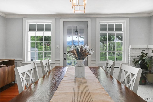 2875 W Lake Rd, Cazenovia, NY 13035 - dining area featuring a decorative wall, wainscoting, ornamental molding, and a chandelier
