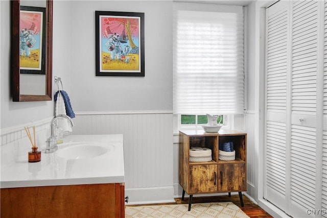 2875 W Lake Rd, Cazenovia, NY 13035 - bathroom with a wainscoted wall, vanity, and wood finished floors