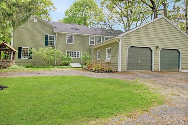 2875 W Lake Rd, Cazenovia, NY 13035 - rear view of house featuring a yard, driveway, and a garage