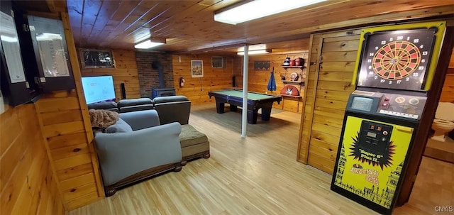24142 County Route 54, Brownville, NY 13634 - playroom featuring a wood stove, wood finished floors, pool table, wood ceiling, and wood walls