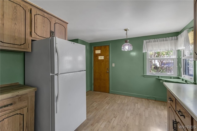 438 Zimmerman Blvd, Tonawanda-Town, NY 14223 - kitchen with freestanding refrigerator, light wood-style flooring, light countertops, decorative light fixtures, and brown cabinetry