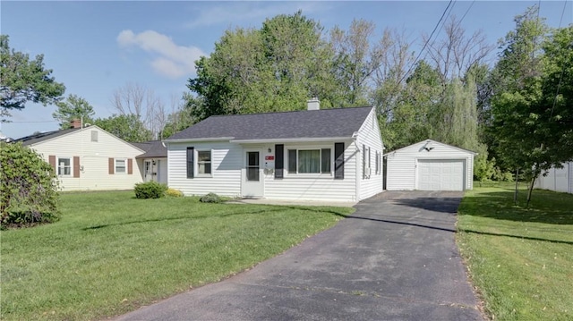 15 Wycliffe Rd, Waterloo, NY 13165 - single story home with an outbuilding, asphalt driveway, a chimney, a front yard, and a detached garage