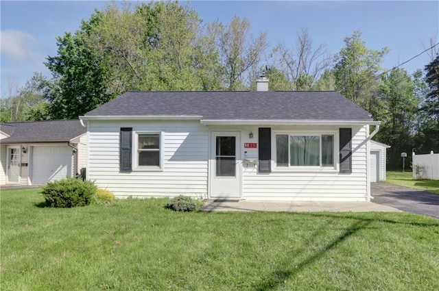 15 Wycliffe Rd, Waterloo, NY 13165 - view of front of home with a front yard, a chimney, a garage, and roof with shingles