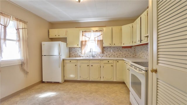 15 Wycliffe Rd, Waterloo, NY 13165 - kitchen featuring white appliances, a sink, light countertops, cream cabinetry, and backsplash