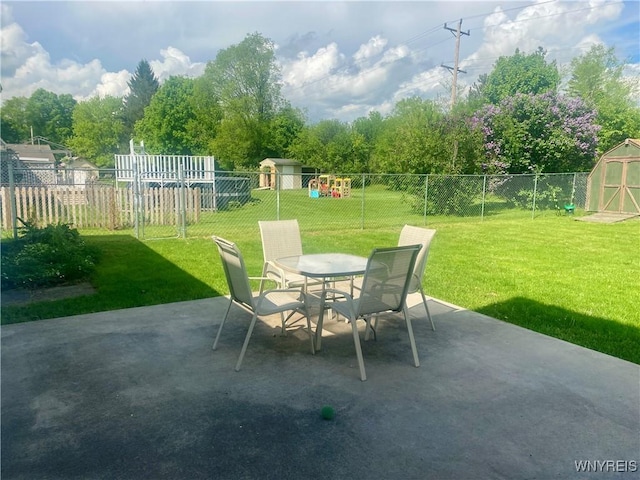 80 Sunnydale Ave, Wellsville, NY 14895 - fenced backyard featuring a storage unit, a patio, and outdoor dining space
