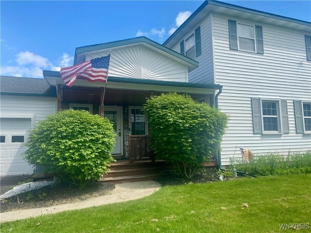 80 Sunnydale Ave, Wellsville, NY 14895 - view of front of house with a front lawn, covered porch, and a garage
