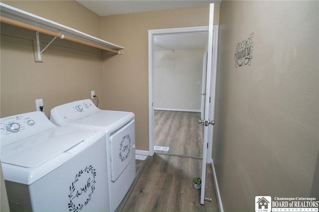 10595 Linwood Dr, Dunkirk-Town, NY 14048 - washroom featuring washing machine and dryer, dark wood-type flooring, and baseboards