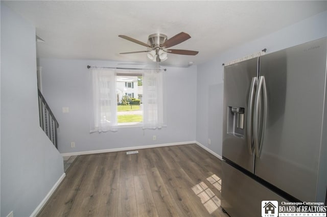 10595 Linwood Dr, Dunkirk-Town, NY 14048 - unfurnished living room with a ceiling fan, dark wood-type flooring, baseboards, and stairs