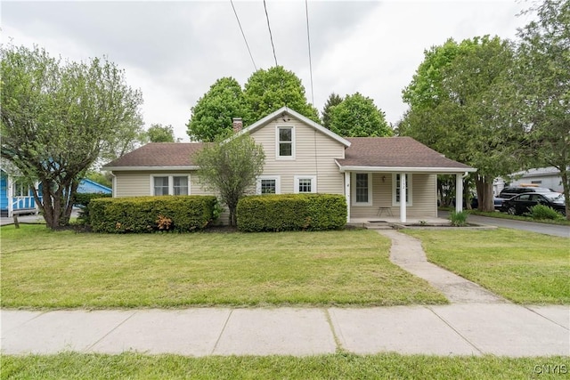 152 Leray St, Le Ray, NY 13612 - view of front facade featuring a porch, a front yard, and a chimney