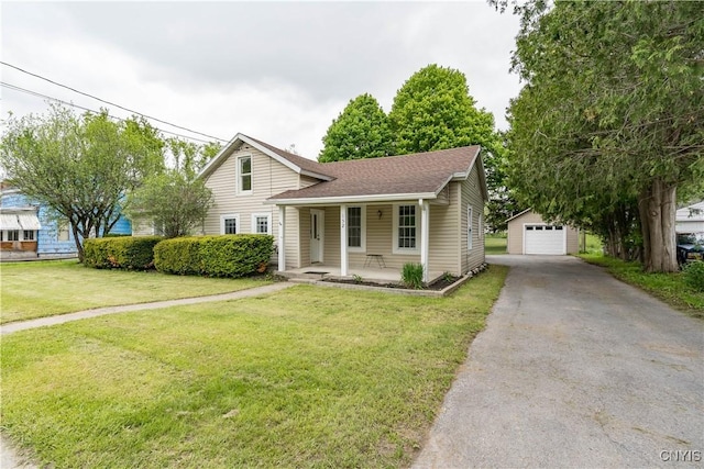 152 Leray St, Le Ray, NY 13612 - view of front of property with an outbuilding, covered porch, a detached garage, and a front yard