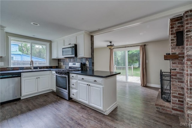 152 Leray St, Le Ray, NY 13612 - kitchen with stainless steel appliances, a sink, dark countertops, and dark wood-style flooring