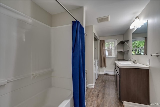 152 Leray St, Le Ray, NY 13612 - bathroom with baseboard heating, wood finished floors, vanity, shower / bath combo with shower curtain, and baseboards