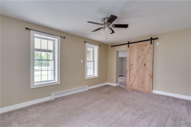 152 Leray St, Le Ray, NY 13612 - empty room with a baseboard radiator, a barn door, carpet, a ceiling fan, and baseboards
