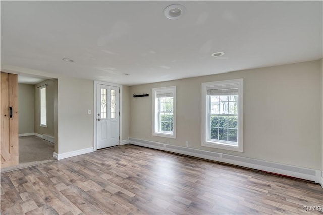 152 Leray St, Le Ray, NY 13612 - entryway featuring wood finished floors, baseboards, baseboard heating, a baseboard radiator, and recessed lighting