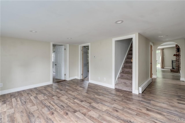 152 Leray St, Le Ray, NY 13612 - unfurnished room featuring arched walkways, wood finished floors, stairs, baseboards, and recessed lighting