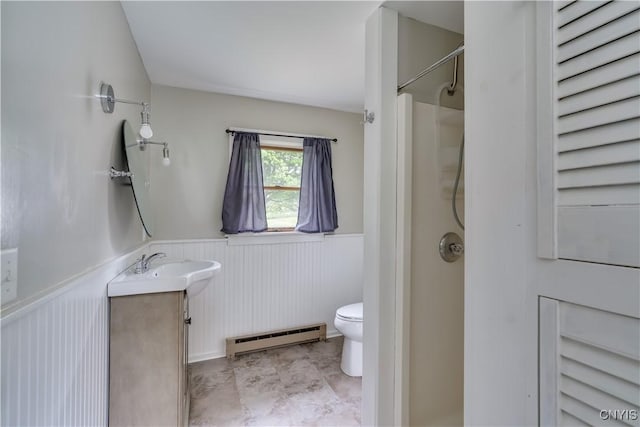 152 Leray St, Le Ray, NY 13612 - bathroom with baseboard heating, wainscoting, toilet, a shower, and vanity