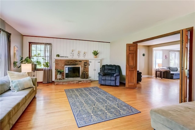 37 York St, Mendon, NY 14472 - living room with light wood finished floors, healthy amount of natural light, and a brick fireplace