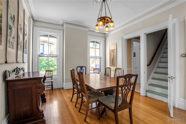 41 Irving Pl, Buffalo, NY 14201 - dining room featuring a chandelier, light wood-style floors, ornamental molding, and stairs