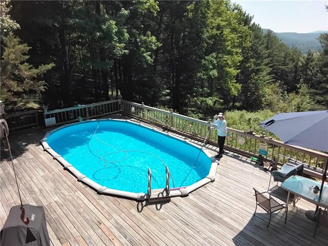 620 Ullas Way, Davenport, NY 13750 - view of swimming pool with a deck and a forest view
