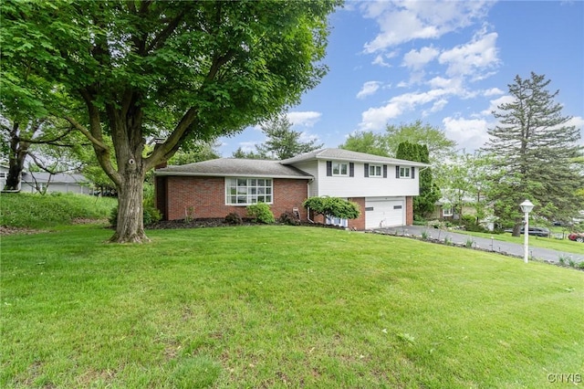 310 Wedgewood Ter, Dewitt, NY 13214 - tri-level home with brick siding, a garage, a front yard, and asphalt driveway