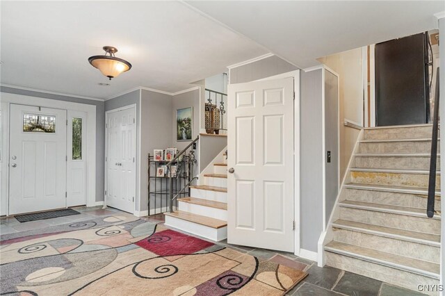 310 Wedgewood Ter, Dewitt, NY 13214 - entryway featuring stairway, baseboards, stone finish floors, and ornamental molding