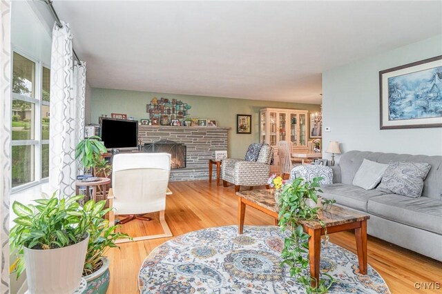 310 Wedgewood Ter, Dewitt, NY 13214 - living area featuring plenty of natural light, wood finished floors, and a fireplace with raised hearth