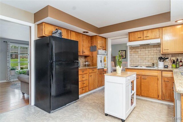 310 Wedgewood Ter, Dewitt, NY 13214 - kitchen with white appliances, under cabinet range hood, and tasteful backsplash