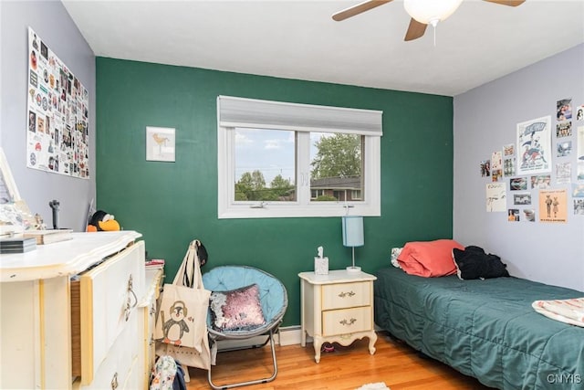 310 Wedgewood Ter, Dewitt, NY 13214 - bedroom featuring light wood-style flooring, ceiling fan, and a baseboard radiator