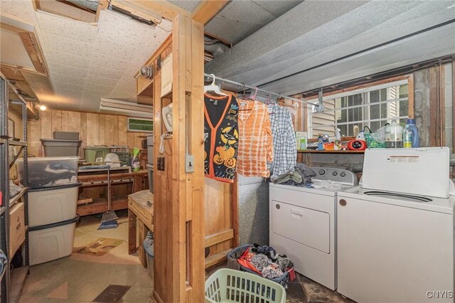 310 Wedgewood Ter, Dewitt, NY 13214 - basement featuring washing machine and clothes dryer, wooden walls, and tile patterned floors