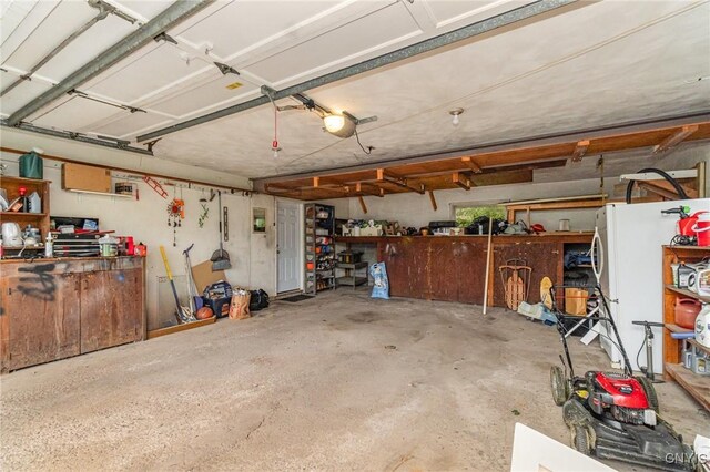 310 Wedgewood Ter, Dewitt, NY 13214 - garage with a workshop area and freestanding refrigerator