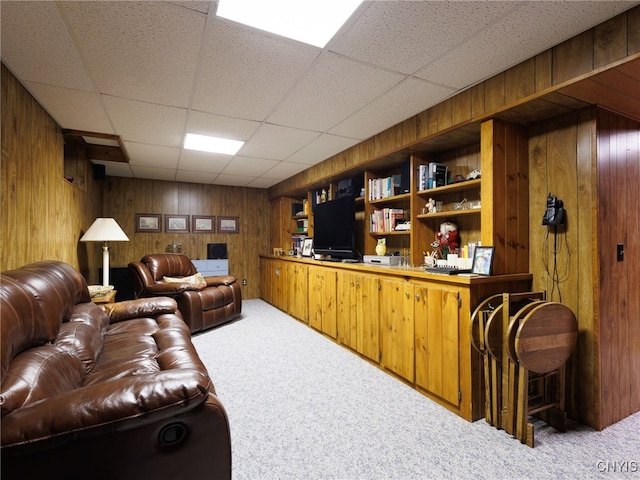 916 State St, Wilna, NY 13619 - living room featuring carpet flooring, wood walls, an office area, and a paneled ceiling