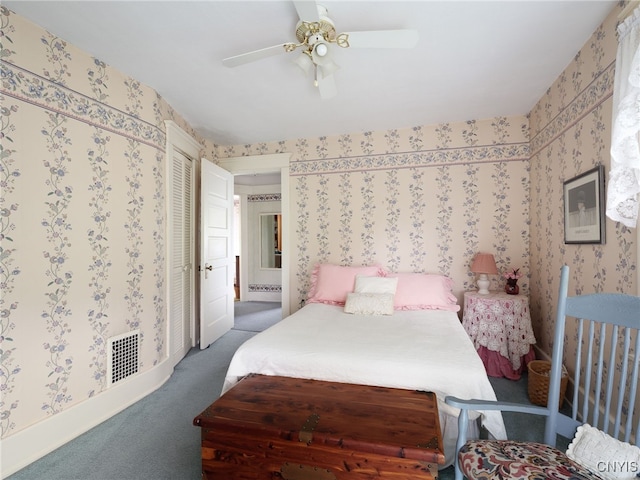 916 State St, Wilna, NY 13619 - carpeted bedroom with wallpapered walls, ensuite bathroom, and ceiling fan