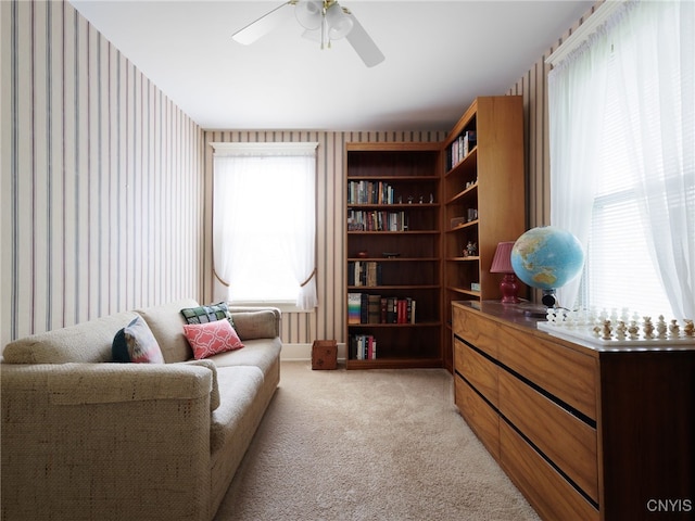 916 State St, Wilna, NY 13619 - sitting room with wallpapered walls, light carpet, and ceiling fan