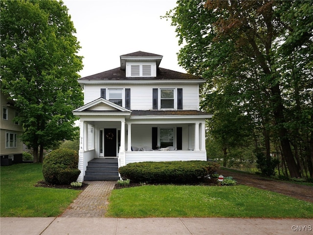 916 State St, Wilna, NY 13619 - american foursquare style home with a front yard, a porch, and central air condition unit