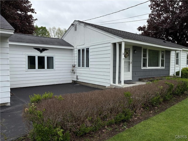 74 Eaton St, Hamilton, NY 13346 - view of property exterior with a patio and a shingled roof