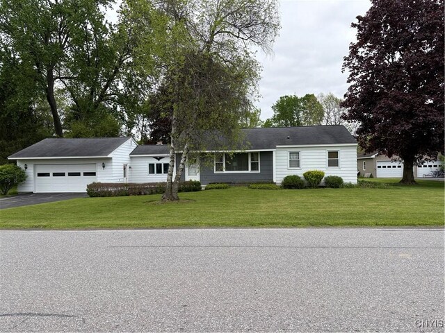 74 Eaton St, Hamilton, NY 13346 - ranch-style home with asphalt driveway, a front yard, and a garage