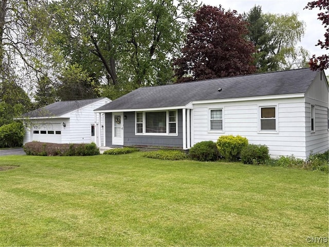 74 Eaton St, Hamilton, NY 13346 - single story home with a front yard, roof with shingles, and a detached garage