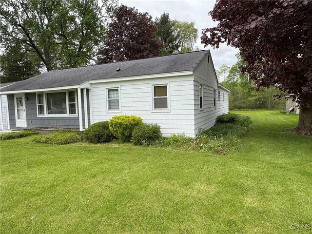 74 Eaton St, Hamilton, NY 13346 - view of side of property featuring a lawn and roof with shingles