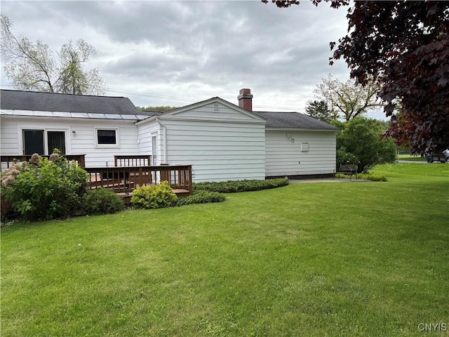 74 Eaton St, Hamilton, NY 13346 - back of property featuring a chimney, a wooden deck, and a lawn