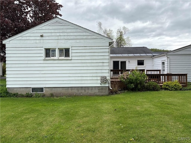 74 Eaton St, Hamilton, NY 13346 - rear view of house featuring a wooden deck and a yard