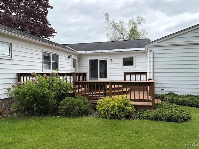 74 Eaton St, Hamilton, NY 13346 - rear view of house featuring a deck and a lawn