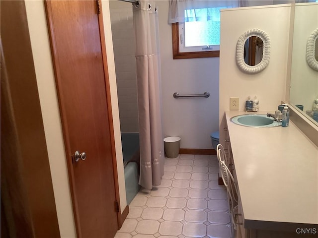 74 Eaton St, Hamilton, NY 13346 - full bathroom with tile patterned floors, toilet, vanity, shower / bath combo, and baseboards