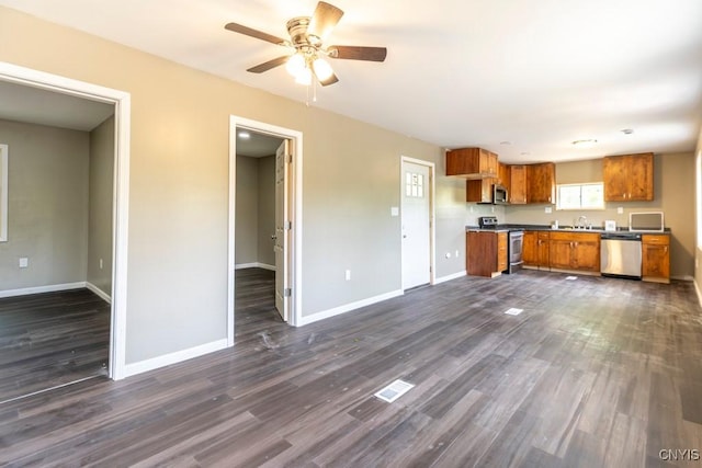 2707 State Route 48, Minetto, NY 13115 - kitchen with appliances with stainless steel finishes, brown cabinetry, dark wood-style flooring, ceiling fan, and baseboards