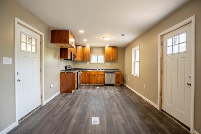 2707 State Route 48, Minetto, NY 13115 - kitchen with stainless steel appliances, brown cabinets, a sink, baseboards, and recessed lighting