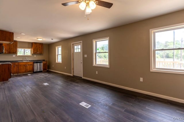 2707 State Route 48, Minetto, NY 13115 - kitchen featuring stainless steel dishwasher, brown cabinets, baseboards, and dark wood-type flooring