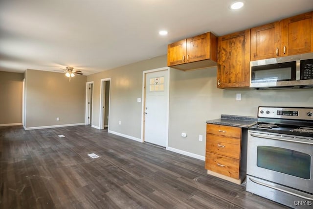 2707 State Route 48, Minetto, NY 13115 - kitchen with appliances with stainless steel finishes, brown cabinets, baseboards, dark countertops, and dark wood-type flooring