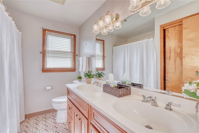 173 Dorian Ln, Greece, NY 14626 - bathroom featuring toilet, double vanity, and baseboards