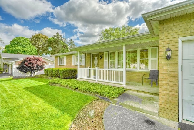 173 Dorian Ln, Greece, NY 14626 - view of green lawn with a porch