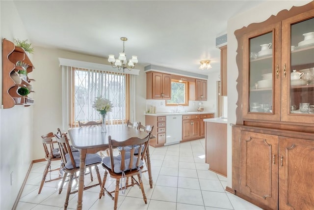 173 Dorian Ln, Greece, NY 14626 - dining room with a chandelier, light tile patterned floors, and baseboards